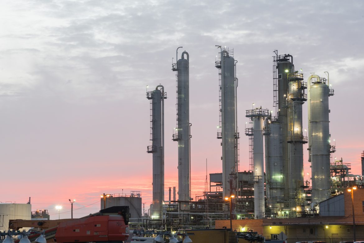 Oil refinery at dramatic sunrise. Oil factory, petrochemical plant in Corpus Christi, Texas, USA. Petroleum industry background.