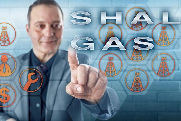 Cheerful industrial manager with toothless smile pushing SHALE GAS on an interactive control screen. Fossil fuel metaphor and energy industry concept for natural gas production from shale formations.