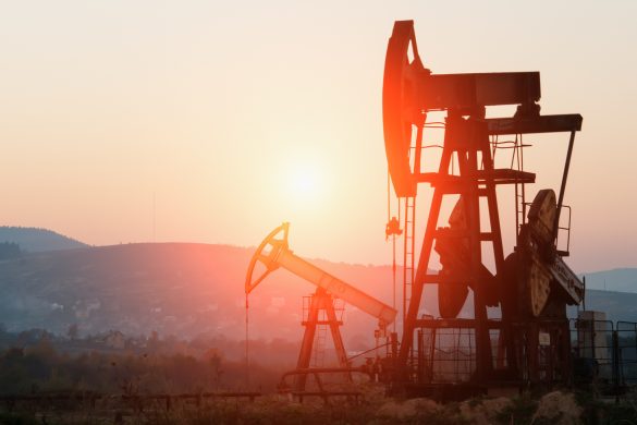 oil pump jack on orange sunset