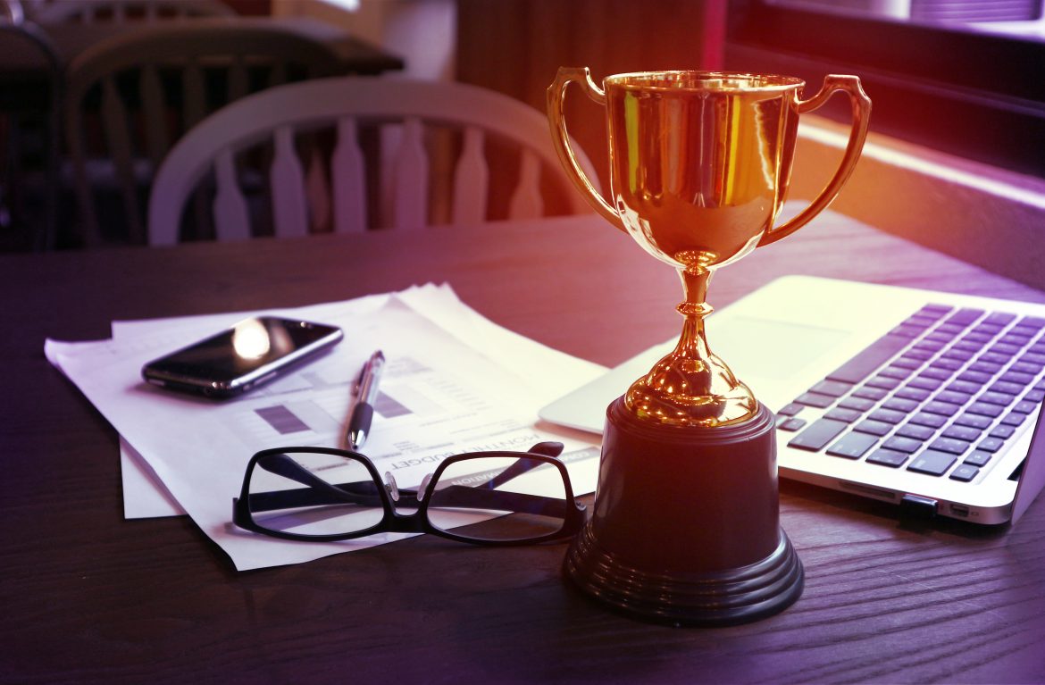 Trophy on work table, win concept