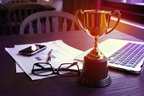 Trophy on work table, win concept