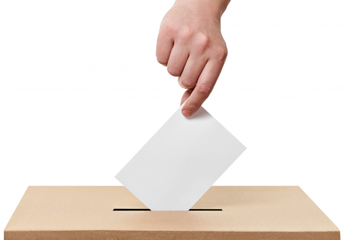close up of a ballot box and casting vote on white background