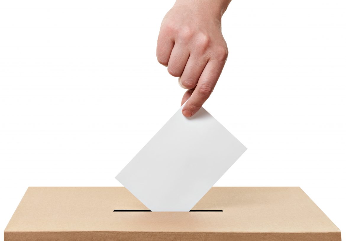 close up of a ballot box and casting vote on white background