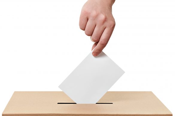 close up of a ballot box and casting vote on white background