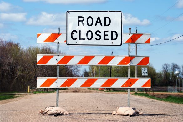 Dusty road closed sign on a country road