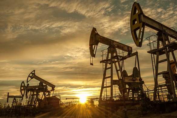 oil and gas pump jack against golden sunset